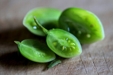 Still green cherry tomatoes cut in half