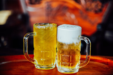 Butter beer and Chrysanthemum Tea in tall glass on wood table.