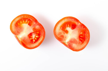 Two red tomatoes in a cut on a white background front and top view.