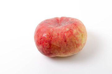 One bright, juicy peach on a white background. Fig peach in close-up on a white background one on one. Water drops on a peach, dew in close-up
