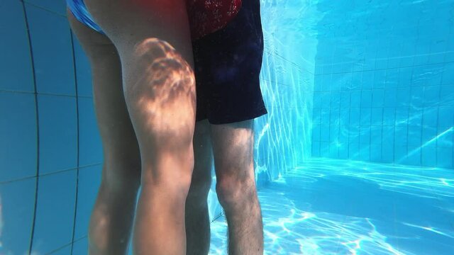 underwater shot of young couple kissing passionately in the pool