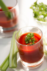 Tomato juice with celery, parsley healthy cocktail for breakfast, close up