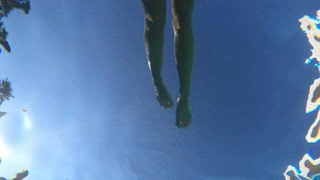 underwater shot of young woman swimming in the pool - enjoy, relax