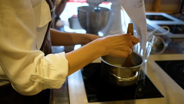 Woman hands whipping with mixer. Making dessert in modern kitchen
