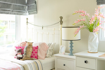 a beautiful bedroom in pastel pink blue with a bedside table with a lamp, bedroom for a girl.