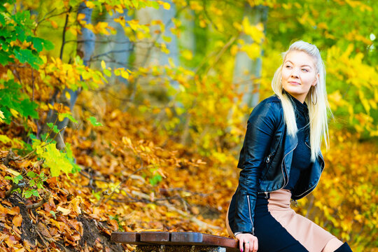 Fashion woman relaxing in autumn park