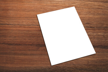 White promotion poster displayed or White paper laid on brown wood panels.  Shop promotion...