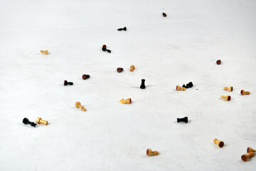 chess pieces falling on the white floor