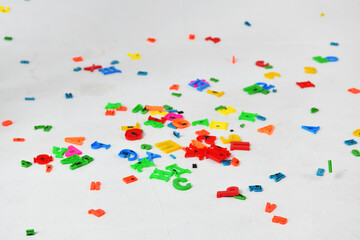 multicolored letters in flight on a white background