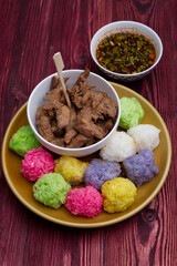 Various Colourful Sticky Rice with Fried Chicken meal on the Wood Table.