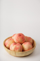 honey peach in wooden bowl