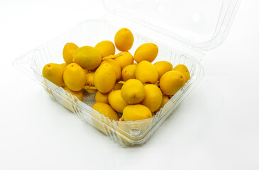 Fresh Date Palm fruit or Date fruit in cleared plastic box or container for sell on white background. Fresh Date fruit in opened cleared packaging.