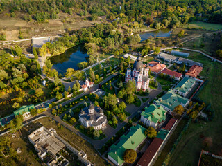Flight over a christian monastery surrounded by autumn forest. Kurky monastery, Moldova republic of. © Igor Syrbu
