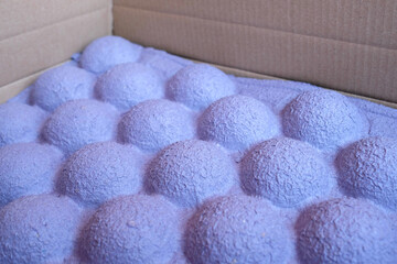 Unusual paper packaging for the transport of goods. Thick purple packaging for the safety of the parcel