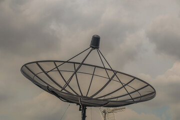 Black Satellite Dish Antenna Receiver Against on Blue Sky background  for Communication and Media Industry, Symbolizing Global Communications. Free copy space for text, No focus, specifically.