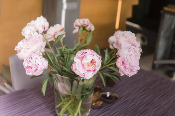pink peony in vase on a table top
