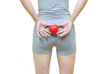 low body of a woman in gray clothes put her hands and red heart on the bottom, Health-care concept on white background