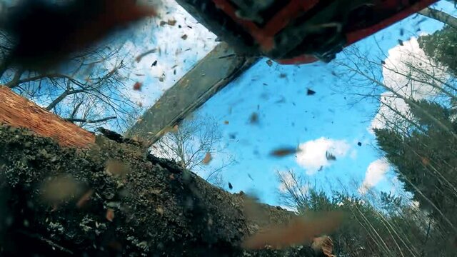 Powersaw is cutting woods with lots of sawdust
