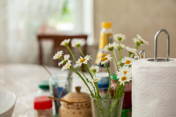 daisies on the table in a vase