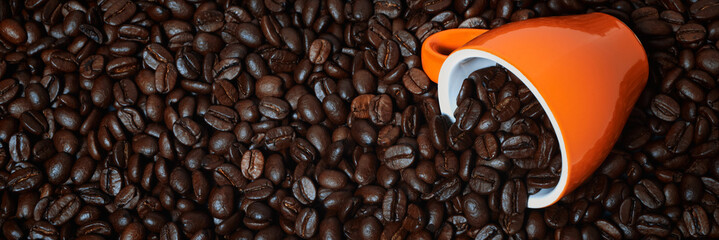 banner of coffee cup laying on coffee beans