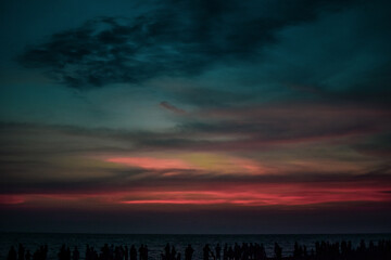 dramatic sky with clouds at the beach during Sunset