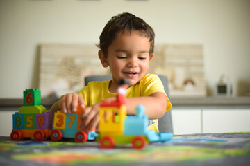 young boy playing home with blocks