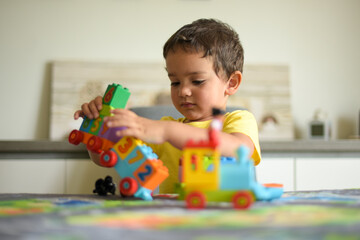 young boy playing home with blocks