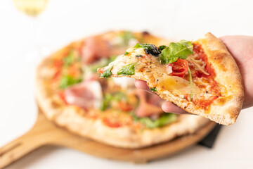 Pizza with mozzarella and raw ham