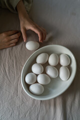 Woman cooking on kitchen. Diet, healthy, organic food cooking - female chef holds in hands eggs.