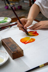 An artist painter is creating traditional Chinese paintings