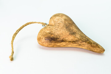 Wooden heart isolated on white background with copy space, view from the top.