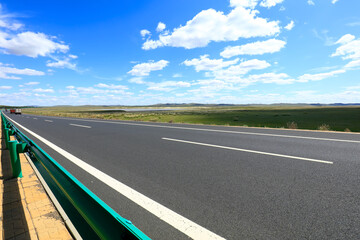 Empty highway, blue sky and white clouds landscape