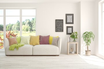 White living room with sofa and summer landscape in window. Scandinavian interior design. 3D illustration