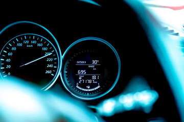 Closeup car fuel gauge dashboard panel. Gasoline indicator meter and speedometer. Fuel gauge show full gas tank. Data information dashboard show outside car temperature, trip range and fuel tank icon.