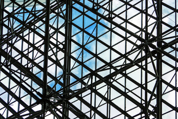 Transparent futuristic glass roof with metal construction of the ceiling
