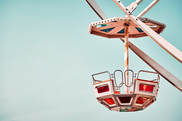 Single Ferris wheel car with cloudless sky in background, color toning applied, space for text. - 366441742