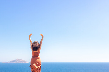 Young girl enjoying vacation, sea and warm breeze, summer vacation