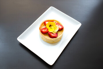Cake with strawberries on a wooden table. Copy space for your text. Flat lay, top view. 