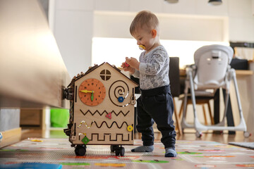 Adorable toddler playing interactive games for good development at home.
