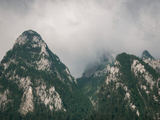 Mountain peak in the clouds. Bucegi mountain part of Carpathian Mountains in Romania.