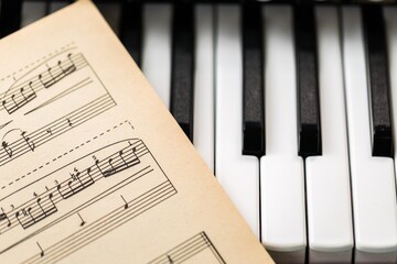 Music Notes Sheet And Piano Keyboard Close-up