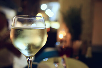 glass white wine restaurant interior, abstract evening dinner with alcohol at the bar