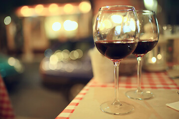 abstract aperitif alcohol glass in a restaurant interior, red wine background