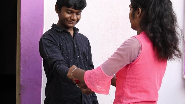 Portrait of an Indian sister tying rakhi to her brother during the Raksha bandhan festival
