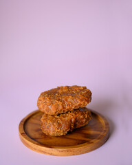 gemblong is Indonesian traditional food from Java, made from white glutinous rice flour dough, isolated on pink background