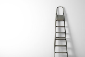 Metal stepladder on white background. Space for text