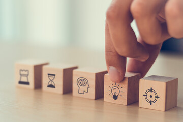 business man hand arranging wood block . icon of business strategy including element with goal,...