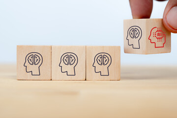 business man hand arranging wooden cube block from human intelligence to artificial intelligence. the job will be replaced by AI in the near future concept