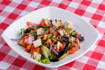 Dietary salad with vegetables, cheese feta, arugula and sauce. Traditional Italian cuisine, Italian concept.
