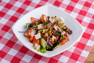 Dietary salad with vegetables, cheese feta, arugula and sauce. Traditional Italian cuisine, Italian concept.
